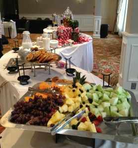 Morning breakfast buffet including fresh cut fruit, danish/pastries, cereal, and yogurt.
