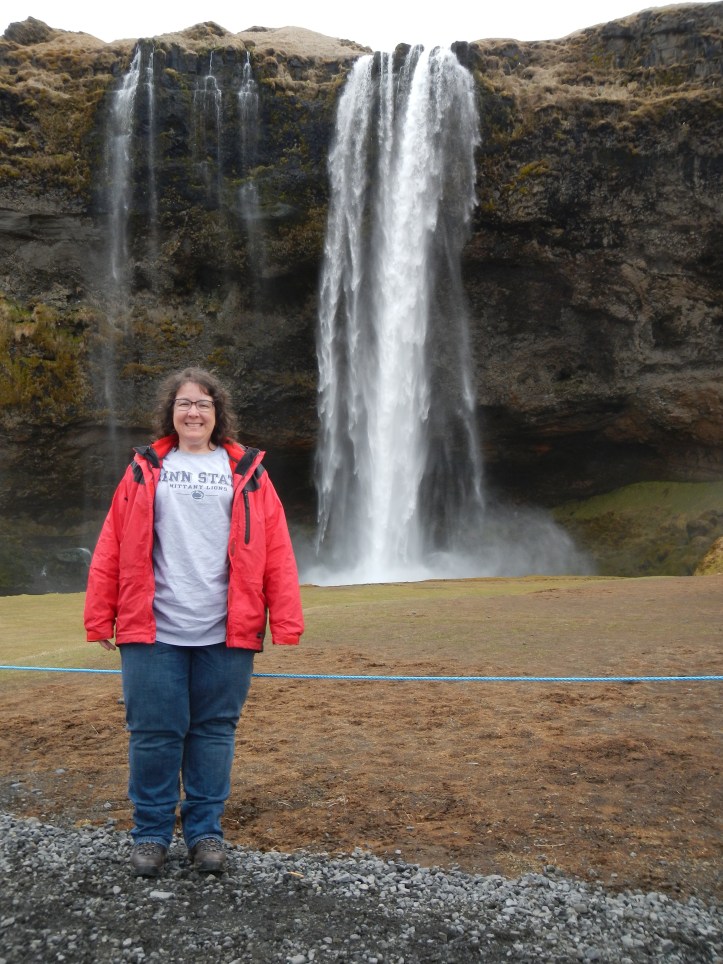 That's me, right before I walked behind this Icelandic waterfall named Seljalandsfoss.