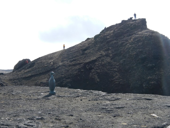 The Great Auk statue on the left, looking out over the ocean.  Behind the statue is the outcrop I climbed to take the photo below.