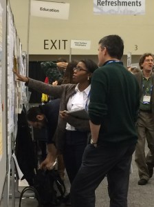 Kimmie presenting her work to one of the conference attendees