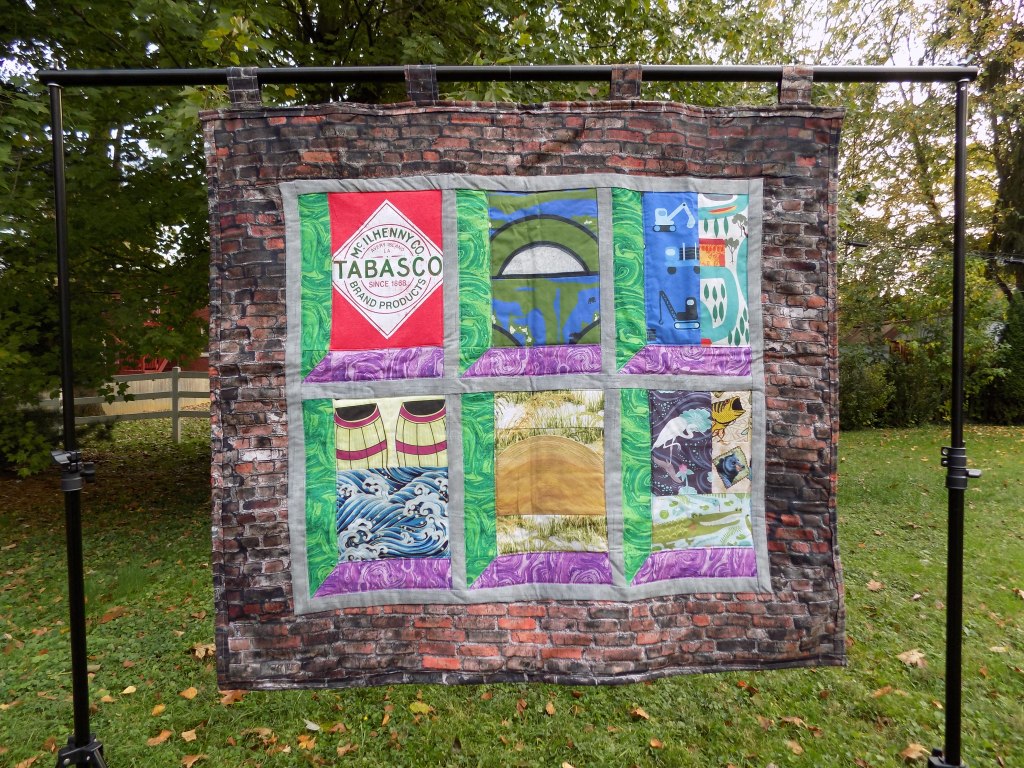 Photo of TABASCO quilt hanging outdoors