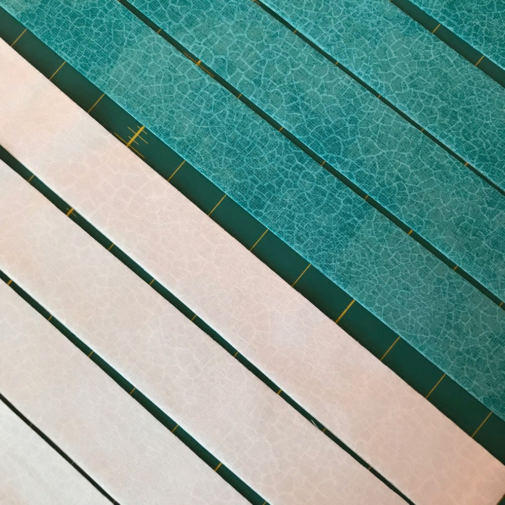 Diagonal strips of white and turquoise fabric