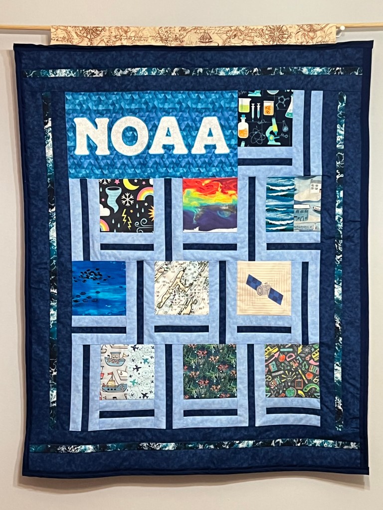 NOAA quilt hanging on wall