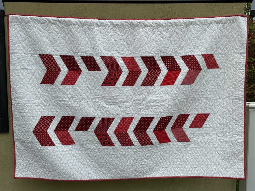 Red and white quilt hanging