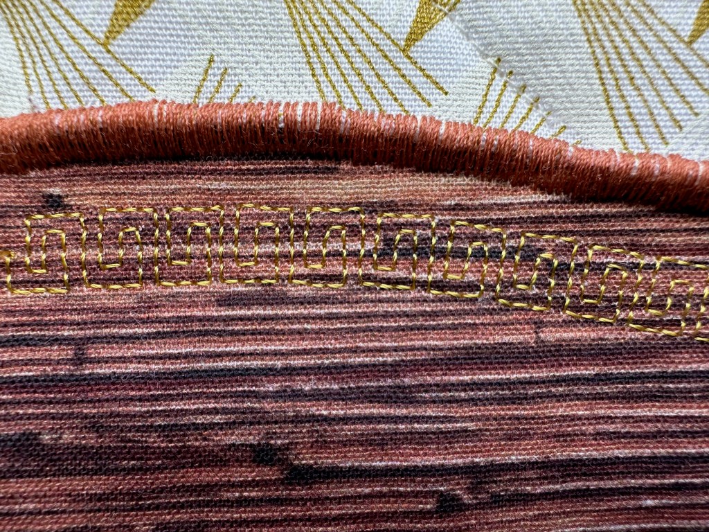 close-up of stitching on globe frame