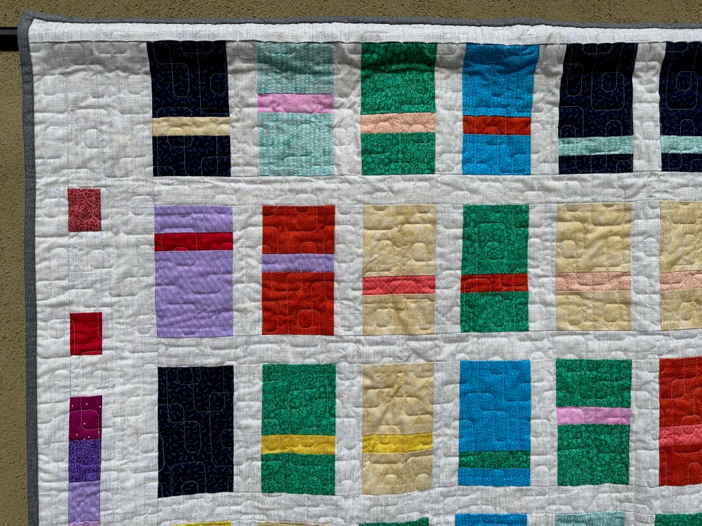 Photo of top left corner of a hanging quilt
