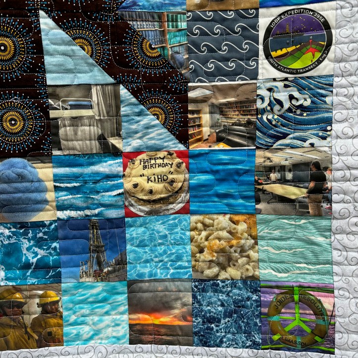 Close of of hanging quilt with fabric squares of different patterns