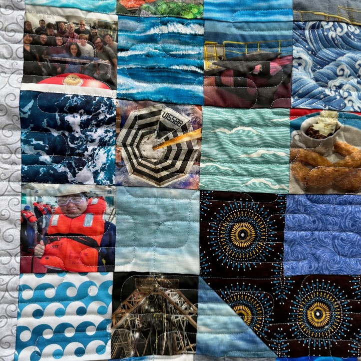 Close of of hanging quilt with fabric squares of different patterns