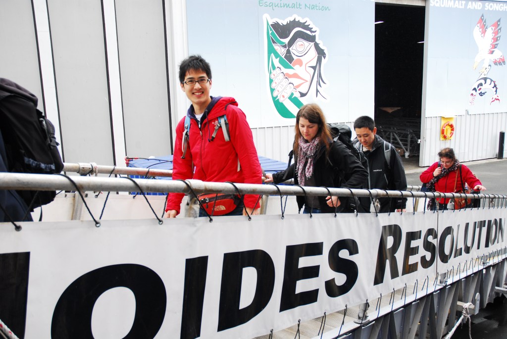 People walking up a gangway towards a ship