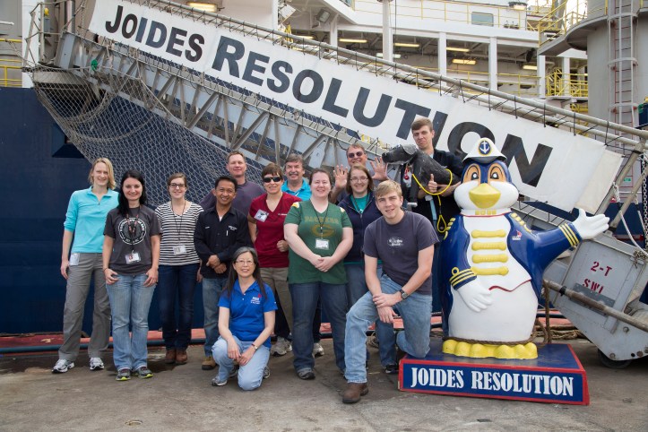 group photo next to a penguin statue
