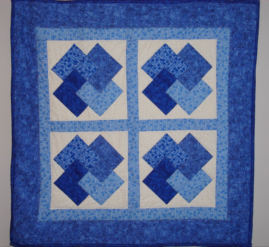 hanging quilt in blue and white colors