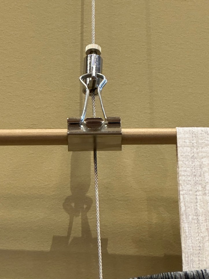 close up of a picture hook and binder clip