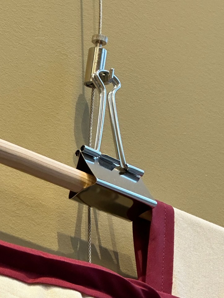 close up of a picture hook and binder clip