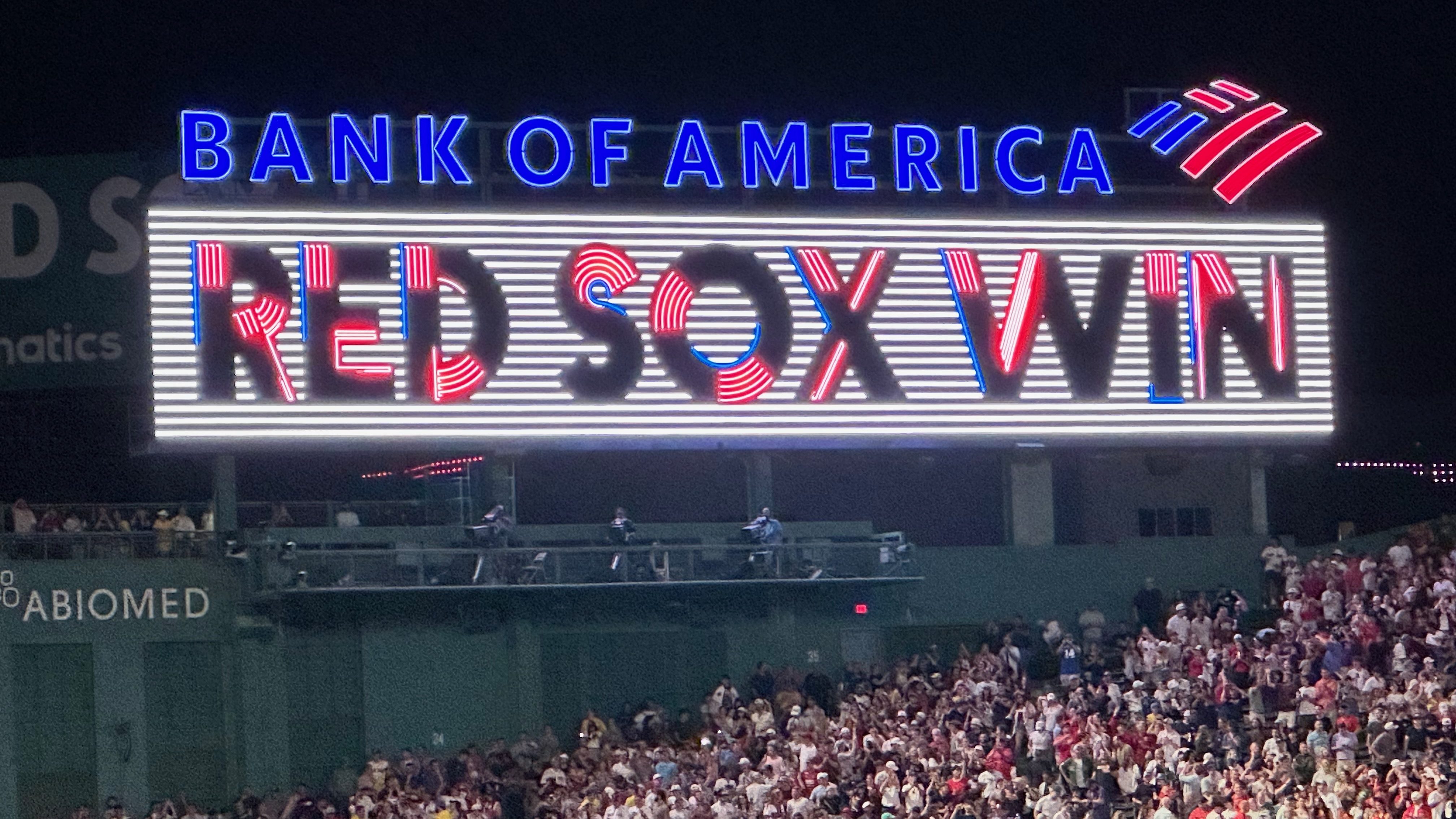 lighted sign at night that says RED SOX WIN