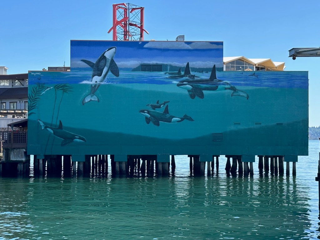 Image of whale mural on the side of a building on the water